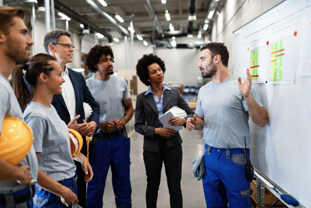 Male staff presenting to company managers and colleagues