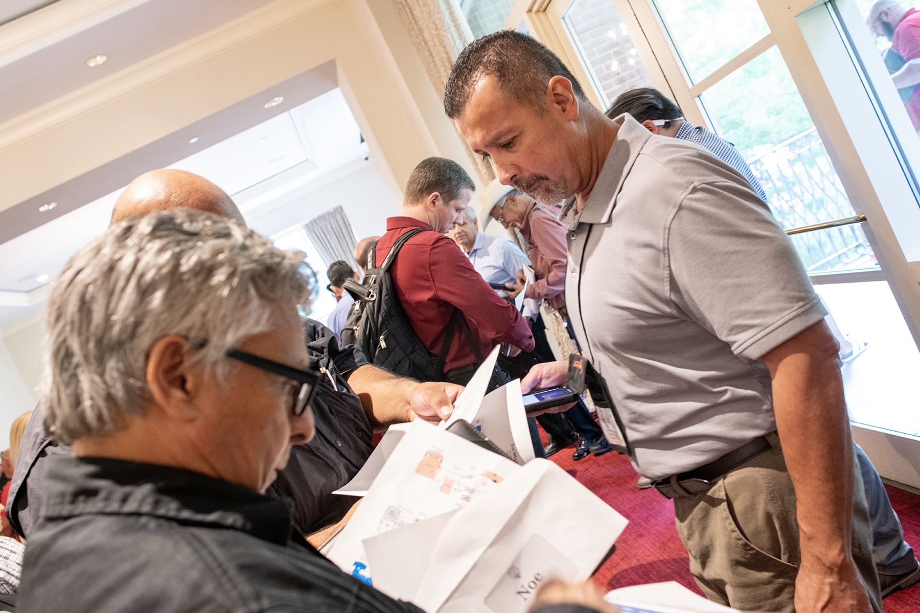 APPAU event photo: attendees looking at pamplet